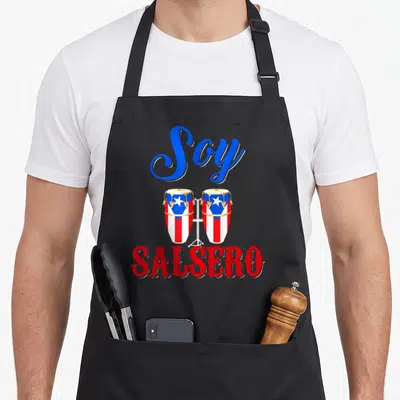 Soy salsero pride apron - Two conga drums with flag pattern and Soy Salsero text in red blue and gold — shown on a black cotton canvas apron against a white background
