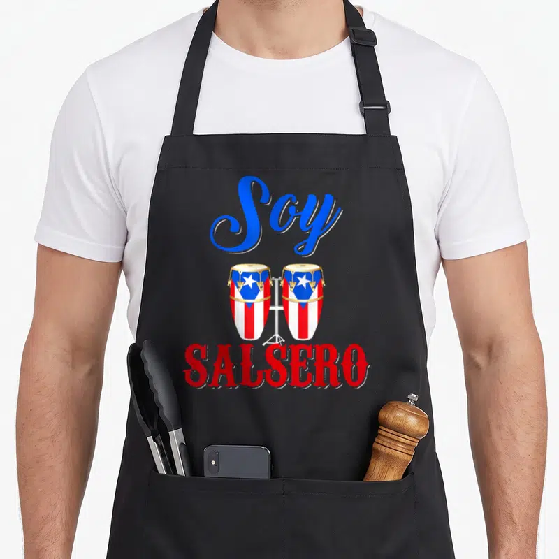 Soy salsero pride apron - Two conga drums with flag pattern and Soy Salsero text in red blue and gold — shown on a black cotton canvas apron against a white background