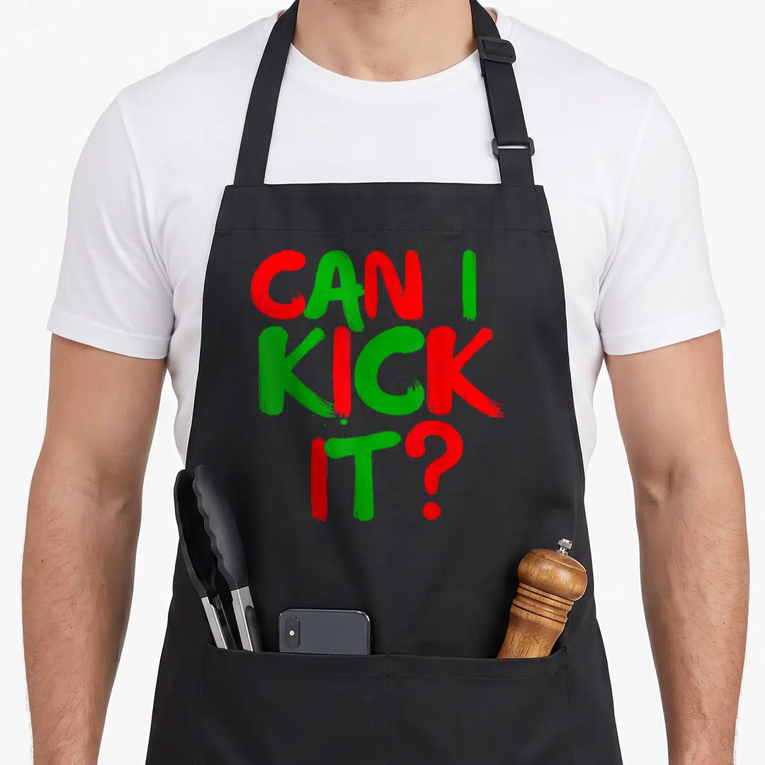 Kick hip aprons - Stacked red and green brushstroke text reading CAN I KICK IT — shown on a black cotton canvas apron against a white background