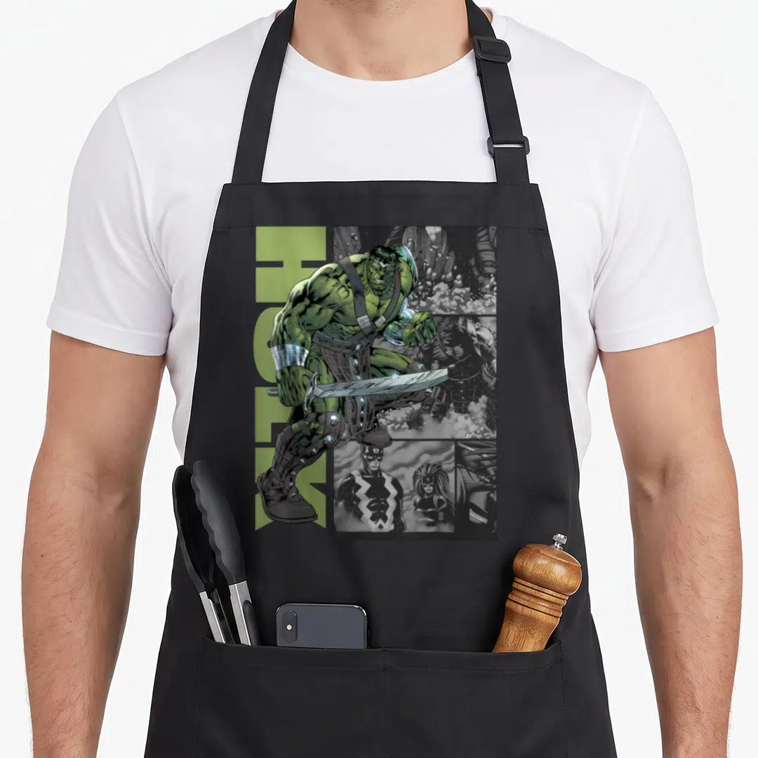 Universe war apron - Green Hulk figure holding sword over grey comic panels with two front pockets — shown on a black cotton canvas apron against a white background