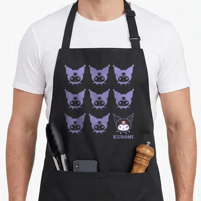 Novelty apron for cooking - Nine Kuromi heads in a grid with purple silhouettes and one full-color face with text — shown on a black cotton canvas apron against a white background