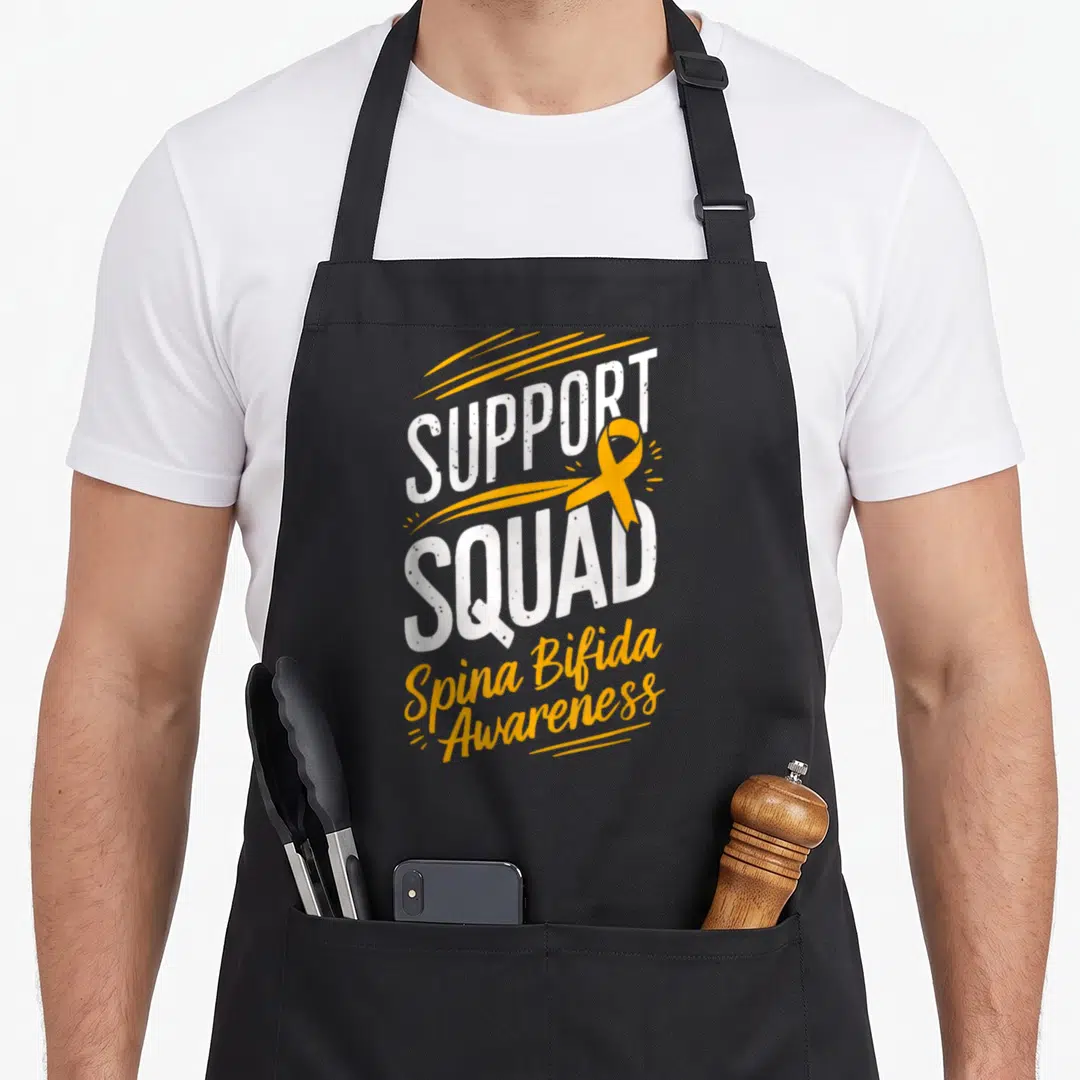 Support squad spina bifida awareness apron - Yellow ribbon and white SUPPORT SQUAD text with Spina Bifida Awareness — shown on a black cotton canvas apron against a white background