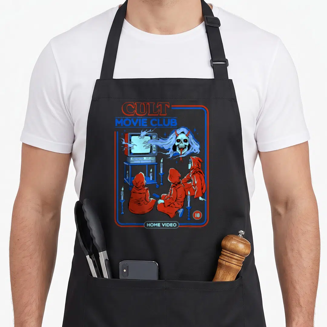 Cult steven rhodes apron - Three robed figures watching TV ghost CULT MOVIE CLUB HOME VIDEO 18 — shown on a black cotton canvas apron against a white background