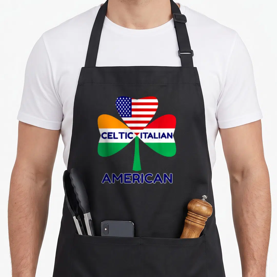 Irish italian aprons - Shamrock filled with US, Irish, and Italian flags and Celtic Italian American text — shown on a black cotton canvas apron against a white background