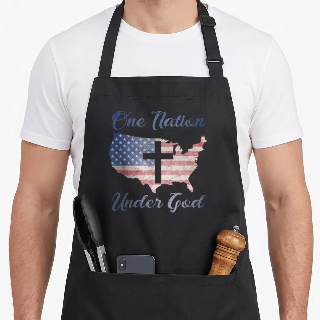Nation american flag apron - Distressed USA map with flag pattern, grey cross, and blue One Nation Under God script — shown on a black cotton canvas apron against a white background