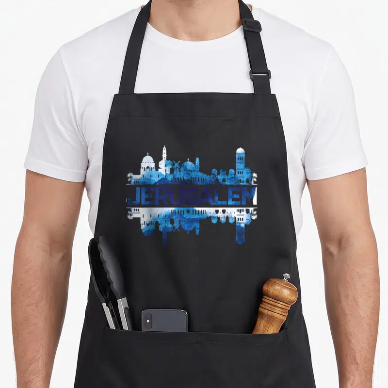 Jerusalem hanukkah apron - Blue and white Jerusalem skyline with centered text and mirrored reflection — shown on a black cotton canvas apron against a white background