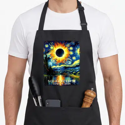 View april apron - Swirling solar eclipse over water and mountains with text SOLAR ECLIPSE APRIL 8 2024 — shown on a black cotton canvas apron against a white background