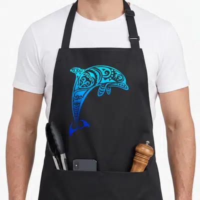 Throwback dolphin apron - Cartoon dolphin filled with blue and cyan tribal swirls and patterns — shown on a black cotton canvas apron against a white background