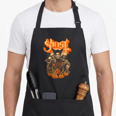 Ghost pumpkin halloween kitchen aprons - Arched Ghost text above Papa Emeritus holding flaming pumpkin surrounded — shown on a black cotton canvas apron against a white background