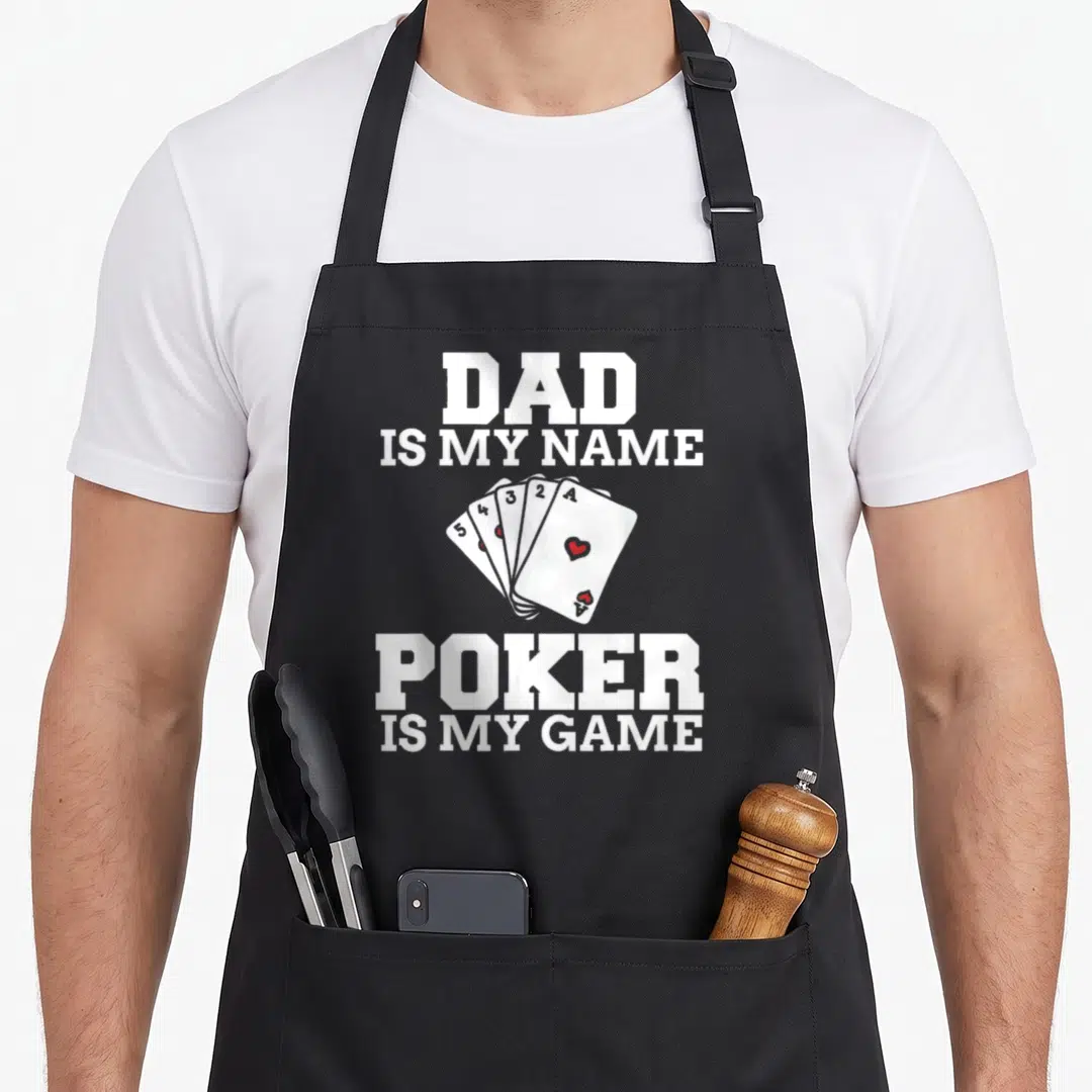 Poker game aprons - White text Dad Is My Name Poker Is My Game around five fanned playing cards with red hearts — shown on a black cotton canvas apron against a white background
