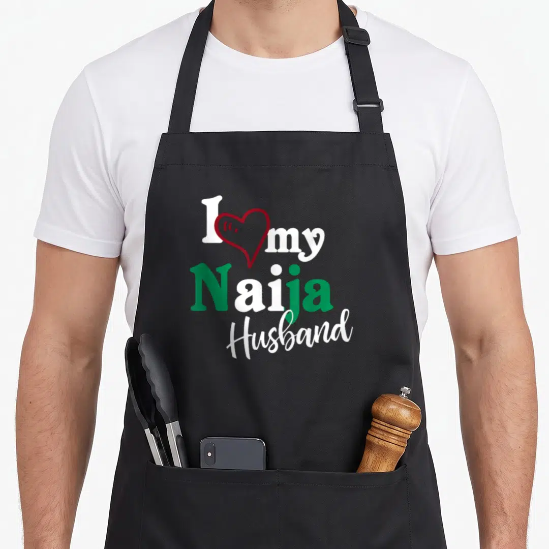 Naija couple apron - I my Naija Husband text with red heart outline in white and green — shown on a black cotton canvas apron against a white background