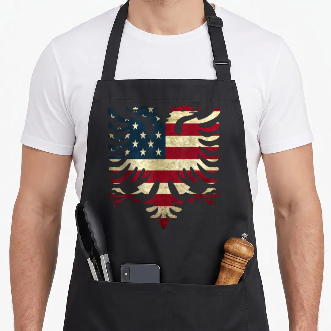 Albanian eagles apron - Double-headed eagle silhouette filled with distressed red white and blue USA flag pattern — shown on a black cotton canvas apron against a white background