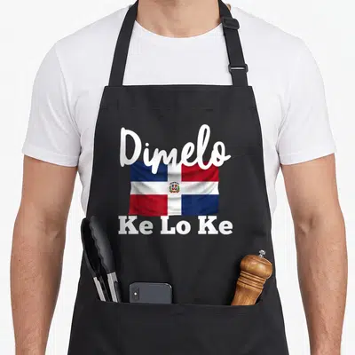 Dimelo pride apron - Realistic Dominican Republic flag with white Dimelo and Ke Lo Ke text — shown on a black cotton canvas apron against a white background