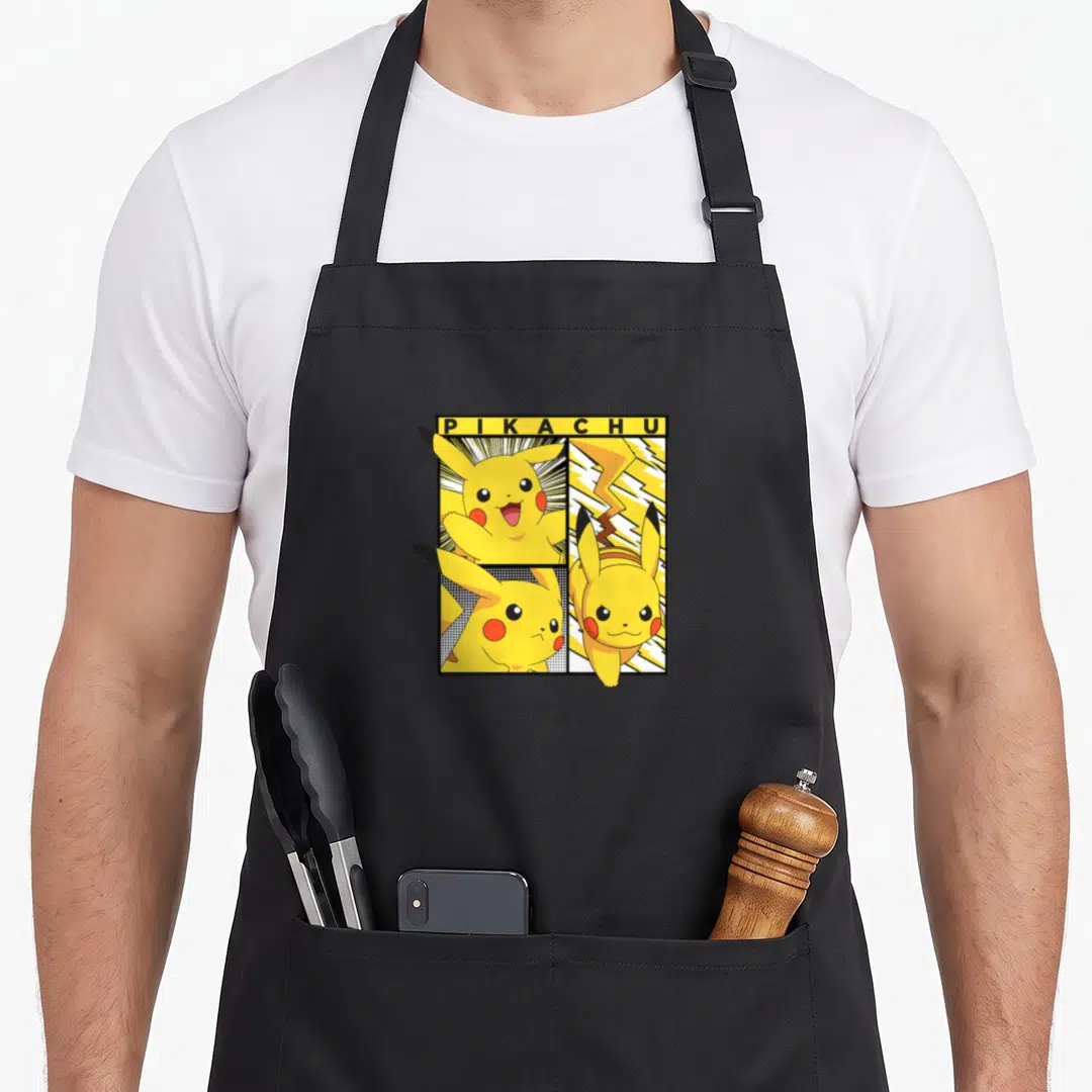 Cool trend apron - Pikachu comic grid with yellow bar text and three cartoon panels — shown on a black cotton canvas apron against a white background