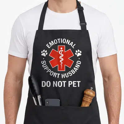 Support husband apron - Red Star of Life with two paw prints and DO NOT PET text — shown on a black cotton canvas apron against a white background