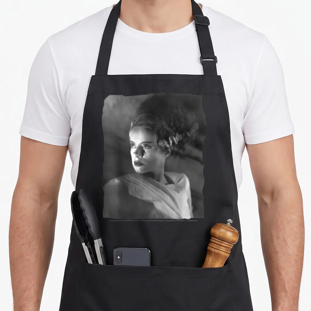 Universal bride apron - Black white gray photo portrait of Bride of Frankenstein centered on canvas — shown on a black cotton canvas apron against a white background