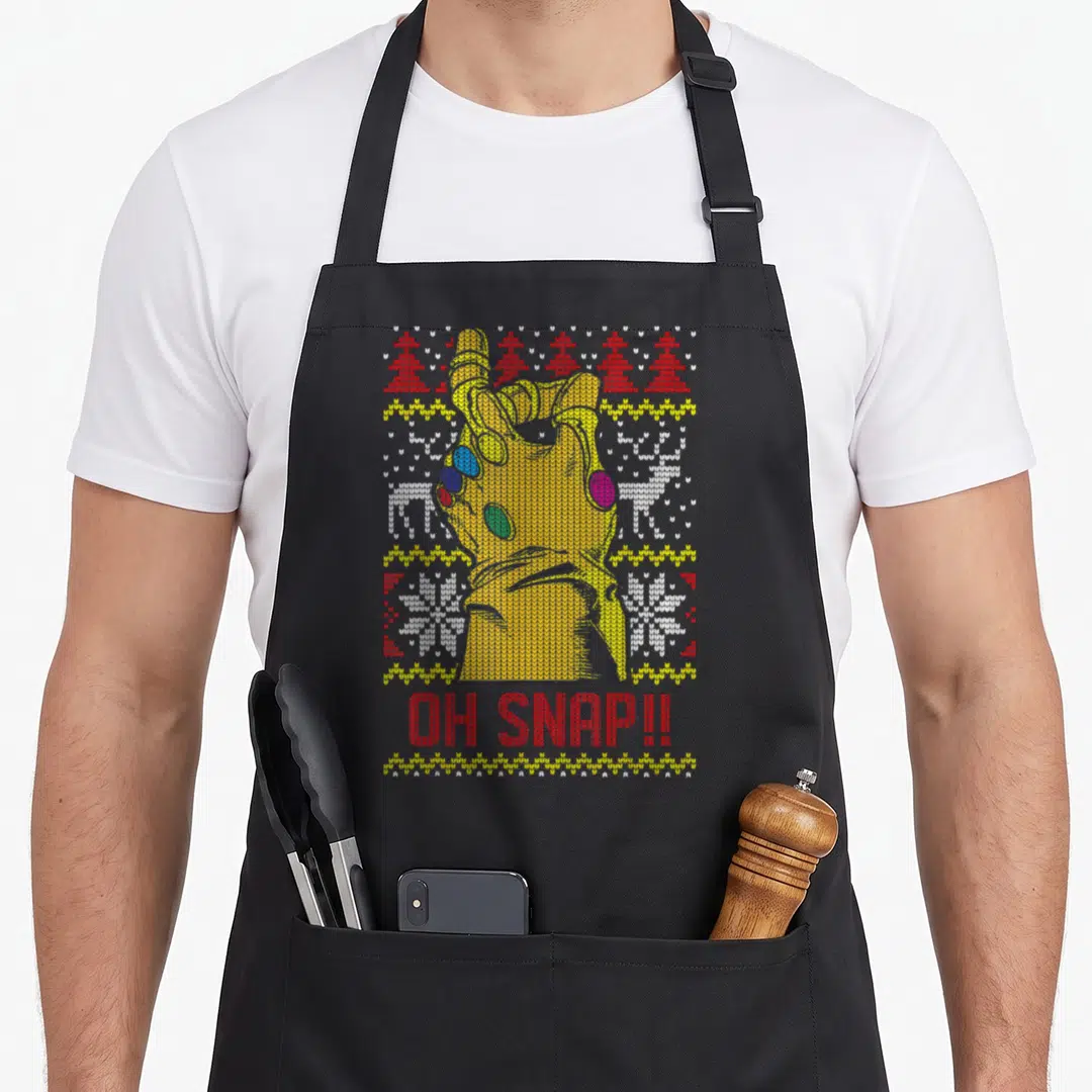 Snap ugly christmas sweater apron - Knitted yellow gauntlet with OH SNAP text and red white patterned stripes — shown on a black cotton canvas apron against a white background