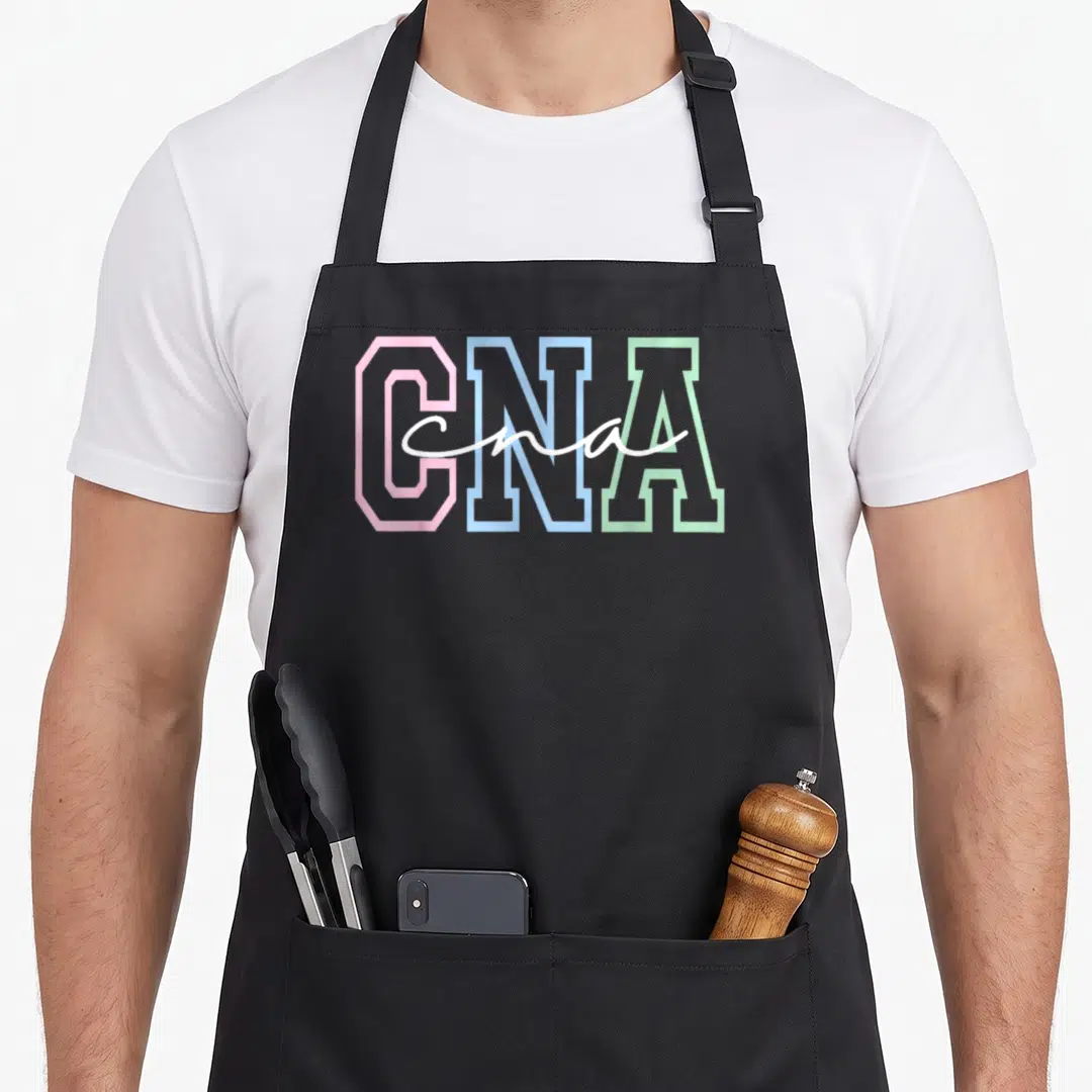 Healthcare nursing aprons - CNA text in pink blue and green with white script overlay — shown on a black cotton canvas apron against a white background