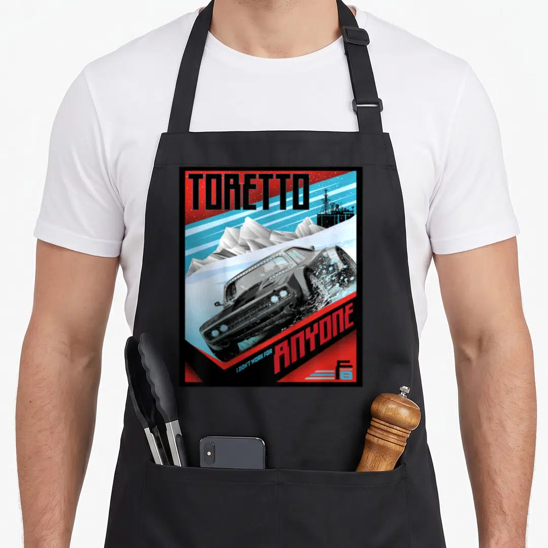 Fate charger apron - Retro poster art of a car drifting in snow with TORETTO text and I DON'T WORK FOR ANYONE slogan — shown on a black cotton canvas apron against a white background