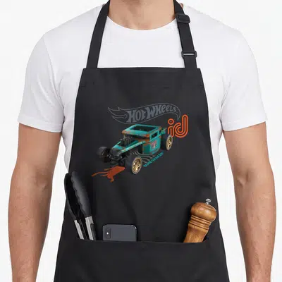 Bone wheel apron - Teal hot rod car with skull grill, rust texture, and bone shaker text — shown on a black cotton canvas apron against a white background