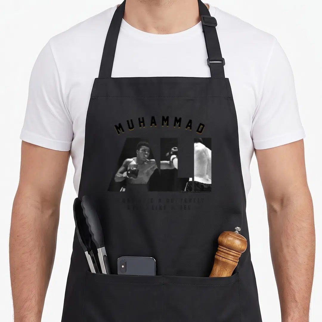 Muhammad bee apron - Muhammad Ali photo text float like a butterfly sting like a bee boxing — shown on a black cotton canvas apron against a white background