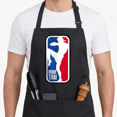 Fighter training apron - White fighter silhouette kicking over blue and red background with MUAY THAI text — shown on a black cotton canvas apron against a white background