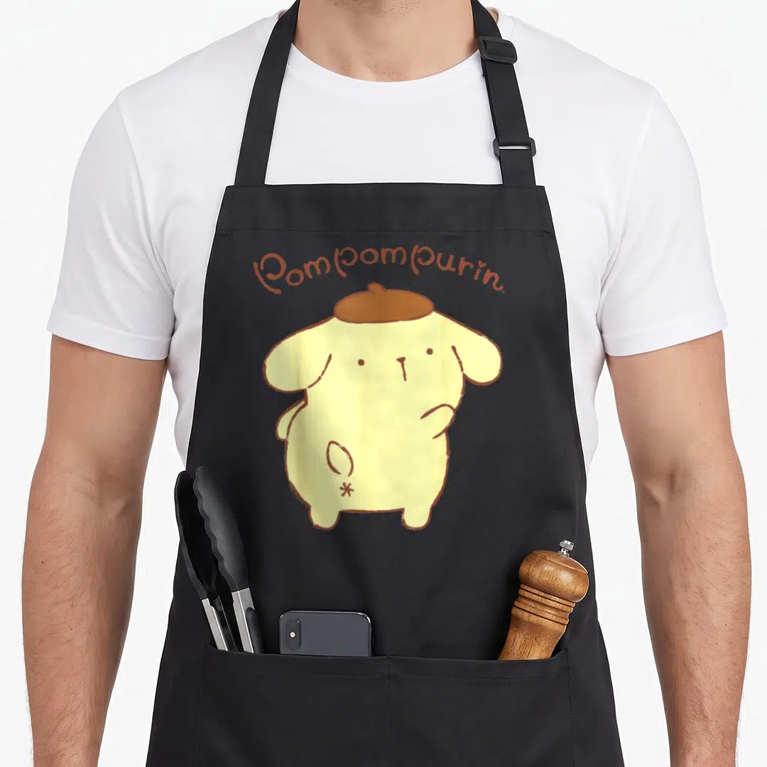 Backside pompompurin apron - Yellow cartoon Pompompurin character viewed from behind wearing a brown beret with arched — shown on a black cotton canvas apron against a white background