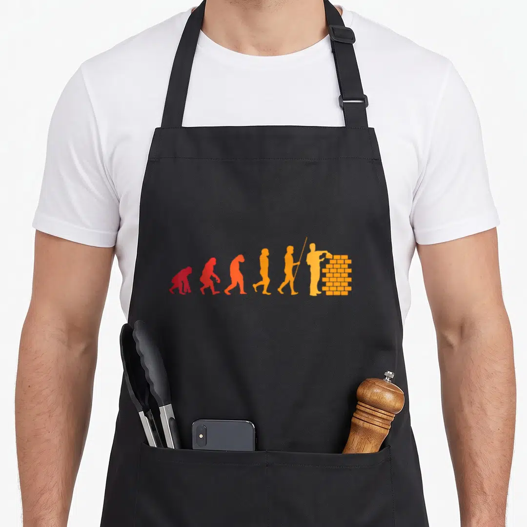 Bricklayer builder apron - Six silhouettes evolving from ape to bricklayer in red orange and yellow gradient — shown on a black cotton canvas apron against a white background