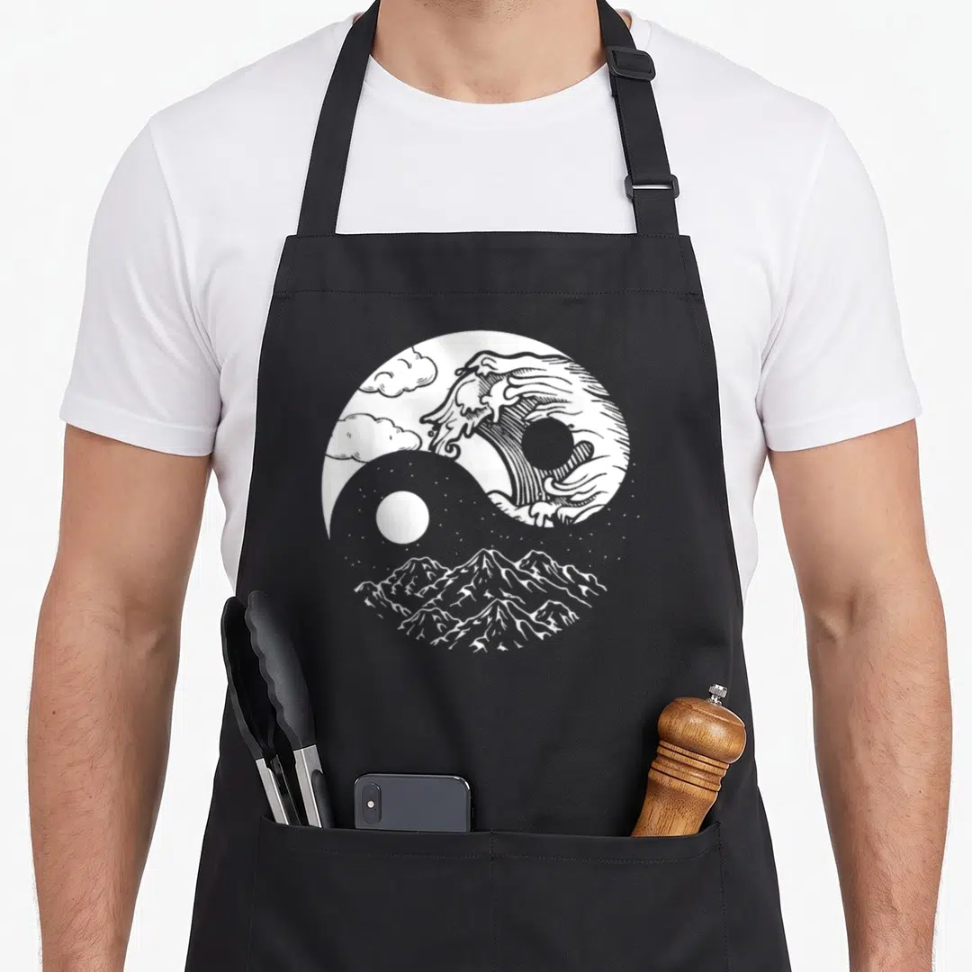 Quigong qigong apron - White line art yin yang circle with waves clouds and mountains — shown on a black cotton canvas apron against a white background
