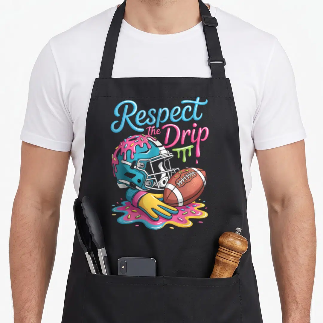 Football sprinkle apron - Respect the Drip text above dripping blue helmet football and glove with sprinkles — shown on a black cotton canvas apron against a white background