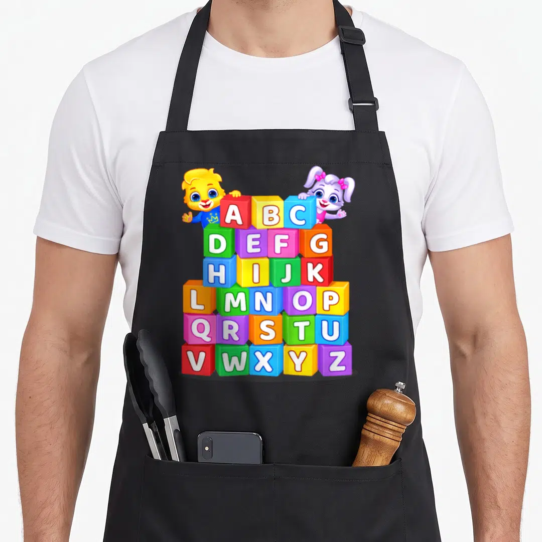 Alphabet colorful aprons - Pyramid of colorful ABC blocks with peeking lion cub and puppy cartoon characters — shown on a black cotton canvas apron against a white background