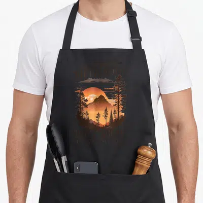 Breath novelty apron - Retro mountain sunset with OUT OF BREATH HIKING SOCIETY text and orange yellow hues — shown on a black cotton canvas apron against a white background