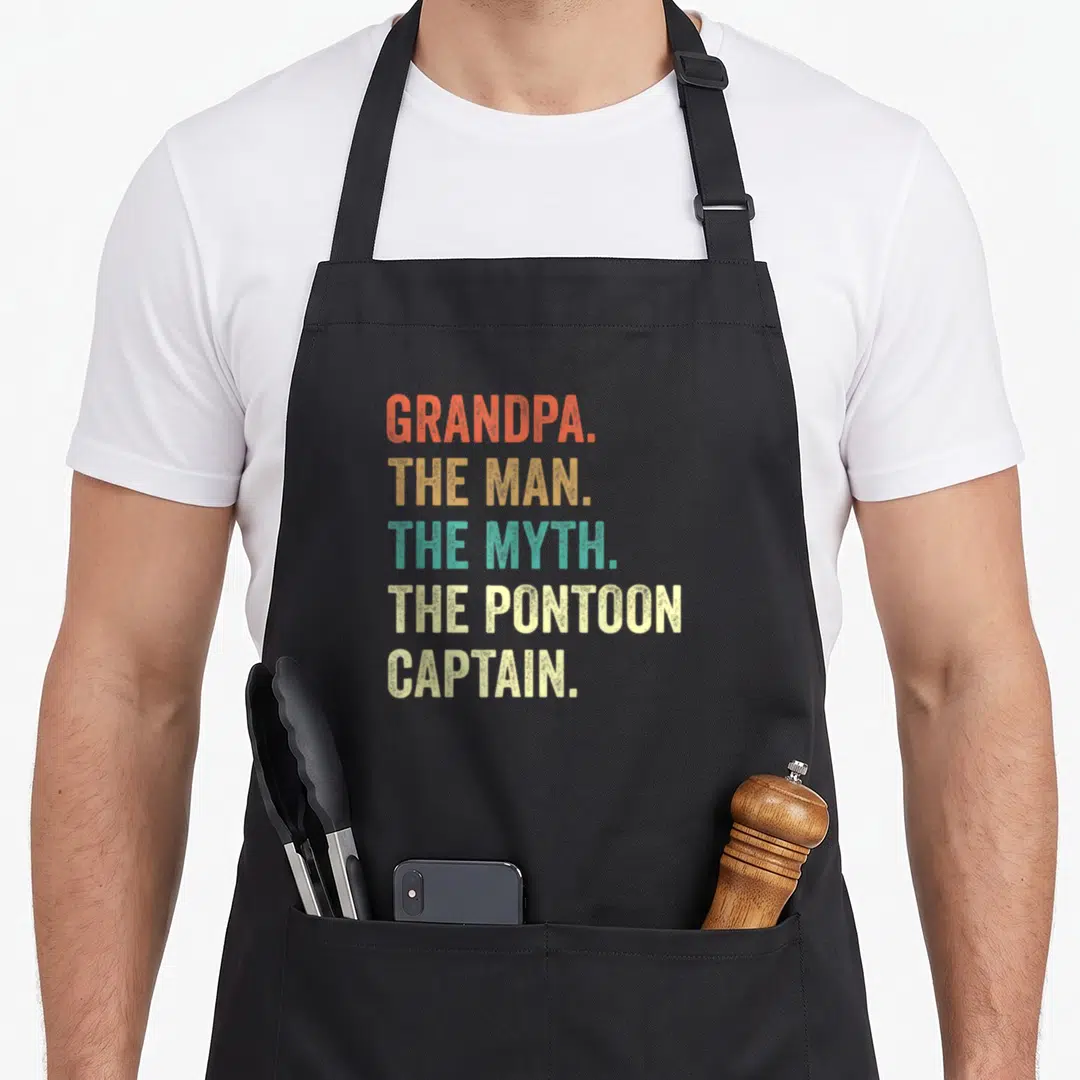 Pontoon grandpa apron - Stacked distressed text in red orange teal and cream reading Grandpa Man Myth Pontoon Captain — shown on a black cotton canvas apron against a white background