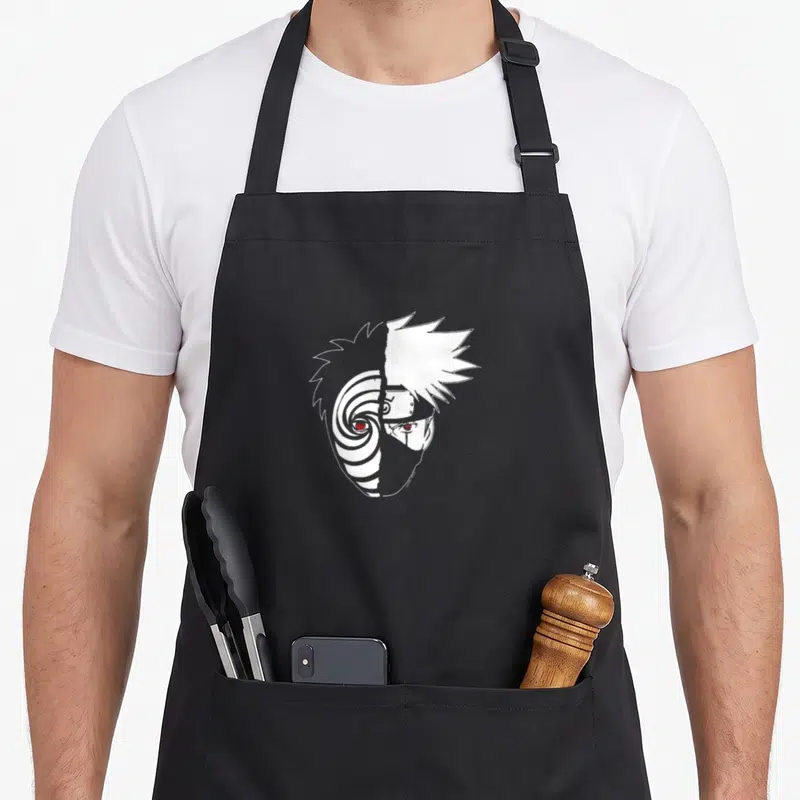 Shippuden split apron - White line art split face with spiral pattern and spiky hair on black apron — shown on a black cotton canvas apron against a white background