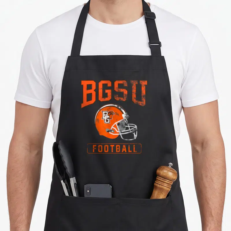 Bowling football apron - Distressed orange BGSU football helmet graphic with text on black bib — shown on a black cotton canvas apron against a white background