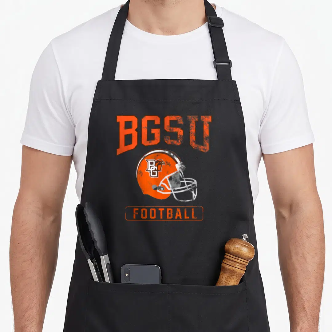 Bowling football apron - Distressed orange BGSU football helmet graphic with text on black bib — shown on a black cotton canvas apron against a white background