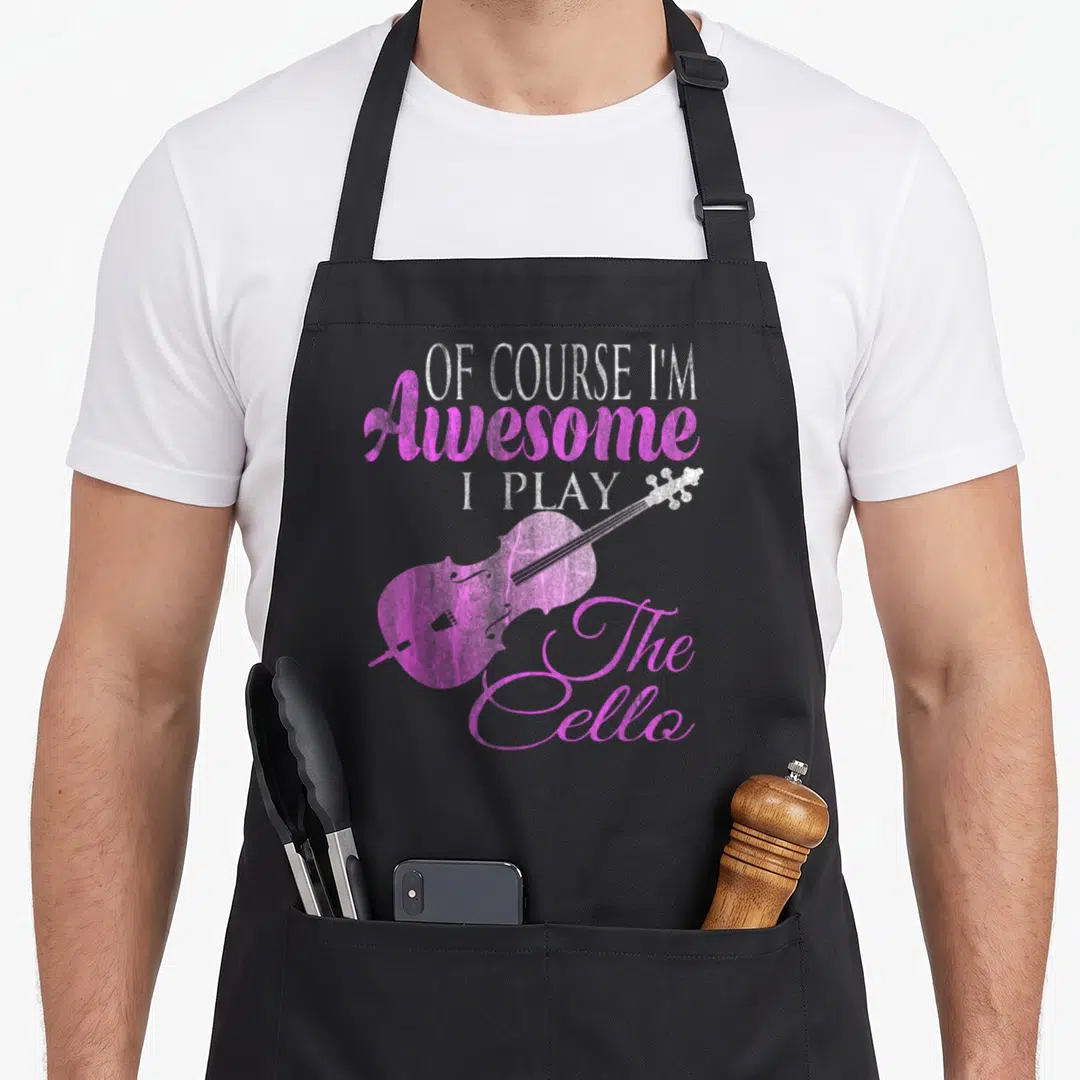 Ich cello apron - Pink cello silhouette with white and pink stacked text OF COURSE I'M Awesome I PLAY The Cello — shown on a black cotton canvas apron against a white background