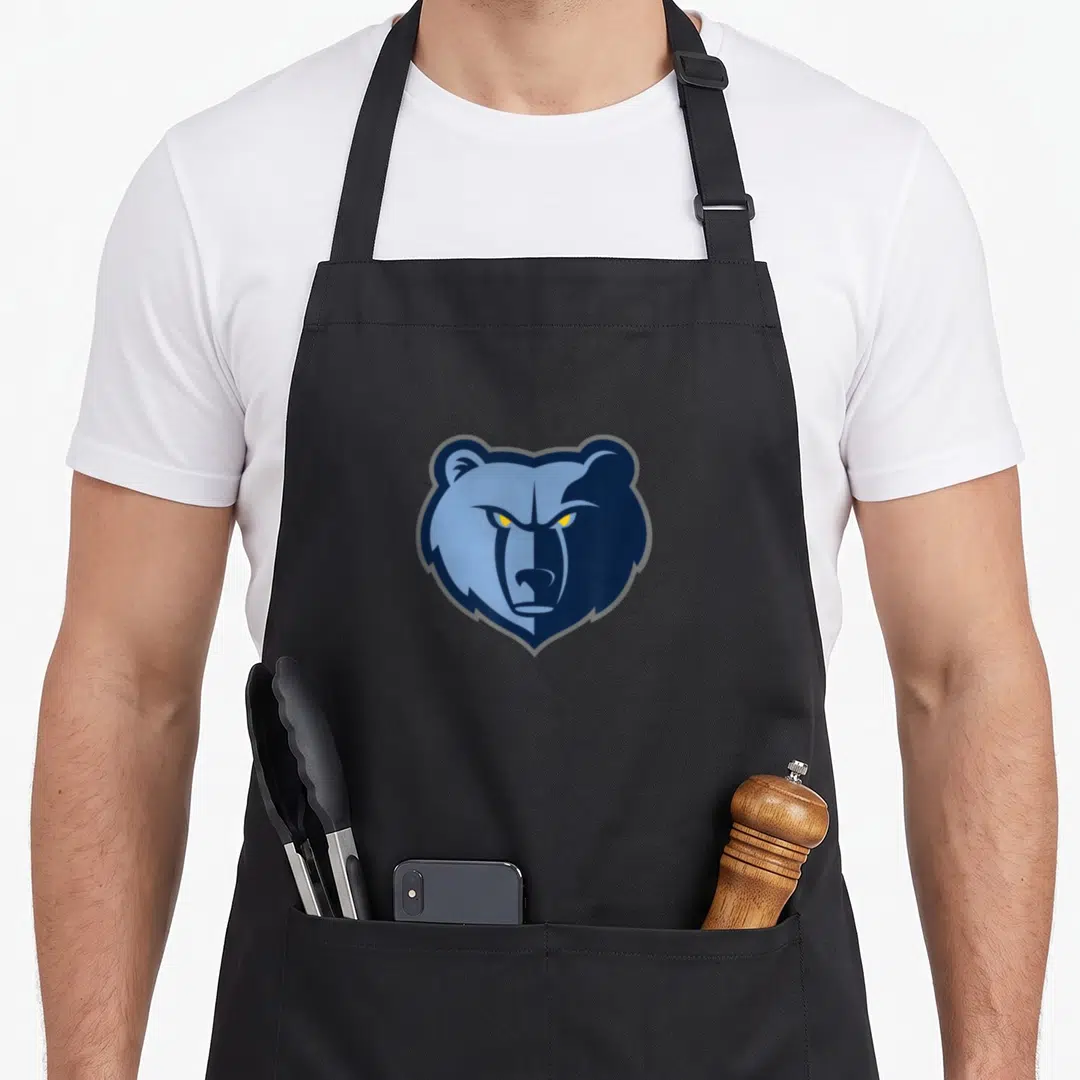 Funny grizzly memphis apron - Stylized blue and yellow cartoon bear head centered on grey background — shown on a black cotton canvas apron against a white background