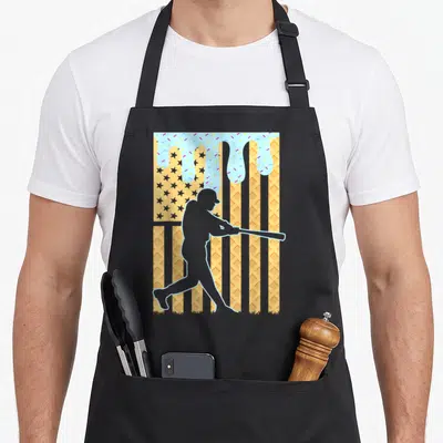 Dripping ice cream apron - Grey batter silhouette on waffle flag background with blue frosting drips and sprinkles — shown on a black cotton canvas apron against a white background