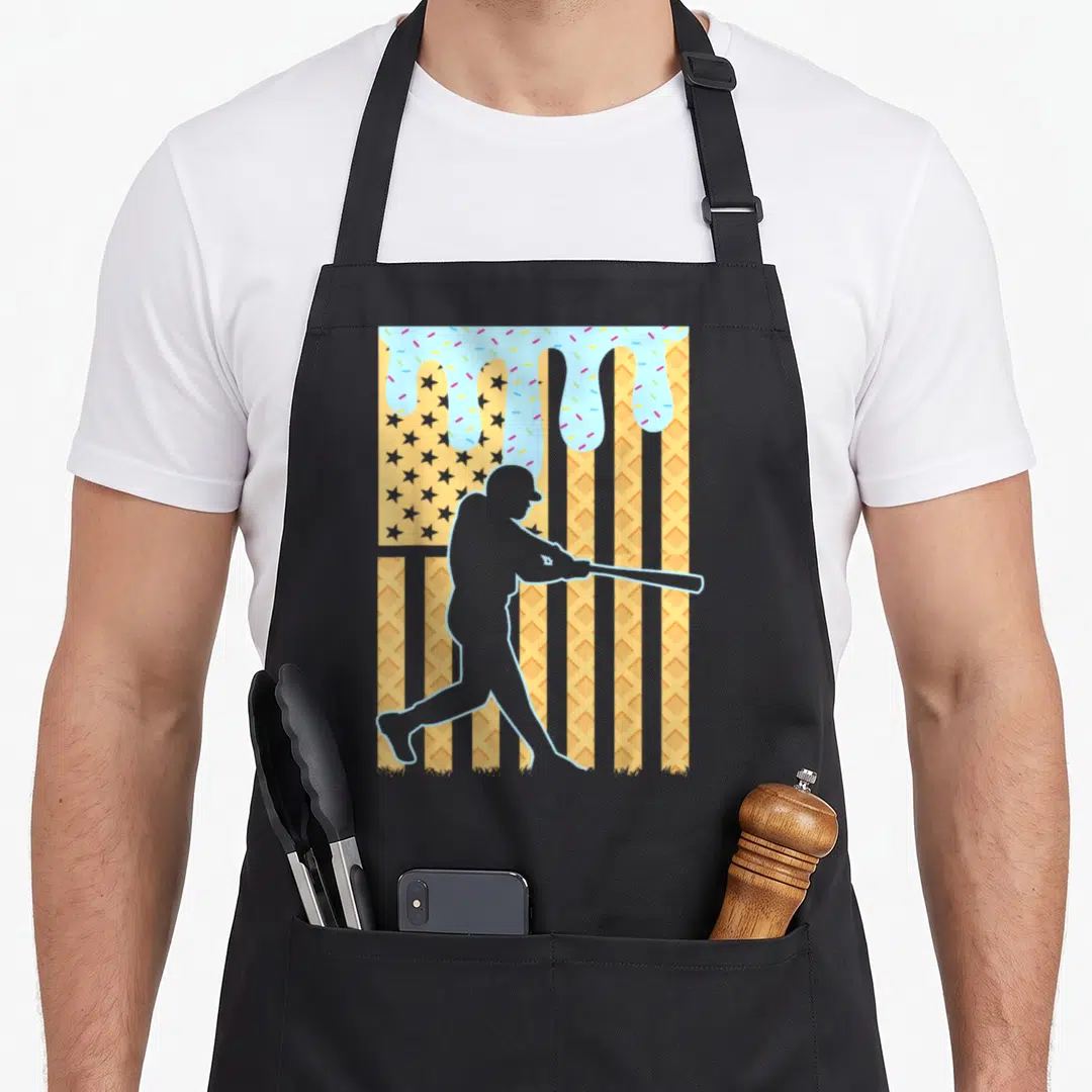 Dripping ice cream apron - Grey batter silhouette on waffle flag background with blue frosting drips and sprinkles — shown on a black cotton canvas apron against a white background