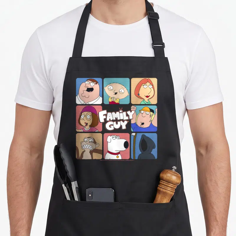 Griffin iconic aprons - Nine-panel cartoon grid with FAMILY GUY logo and characters on striped backgrounds in blue — shown on a black cotton canvas apron against a white background