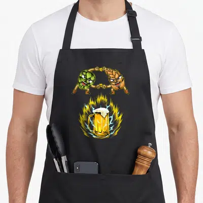 Fusion oktoberfest apron - Cartoon green hop and tan malt touching fingers above a beer mug with lightning and fire — shown on a black cotton canvas apron against a white background