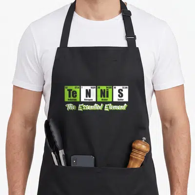 Tennis essential apron - Four periodic table tiles spelling Tennis with The Essential Element text below — shown on a black cotton canvas apron against a white background