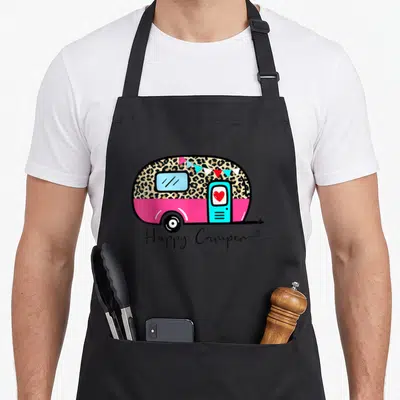 Summer leopard apron - Pink camper with leopard print, bunting, red heart, and Happy Camper script — shown on a black cotton canvas apron against a white background