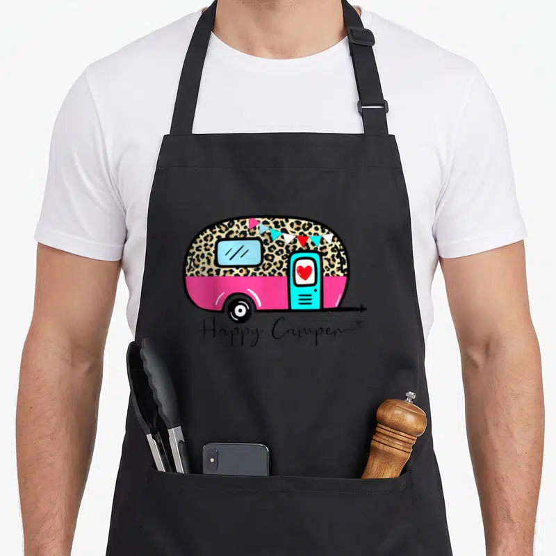 Summer leopard apron - Pink camper with leopard print, bunting, red heart, and Happy Camper script — shown on a black cotton canvas apron against a white background