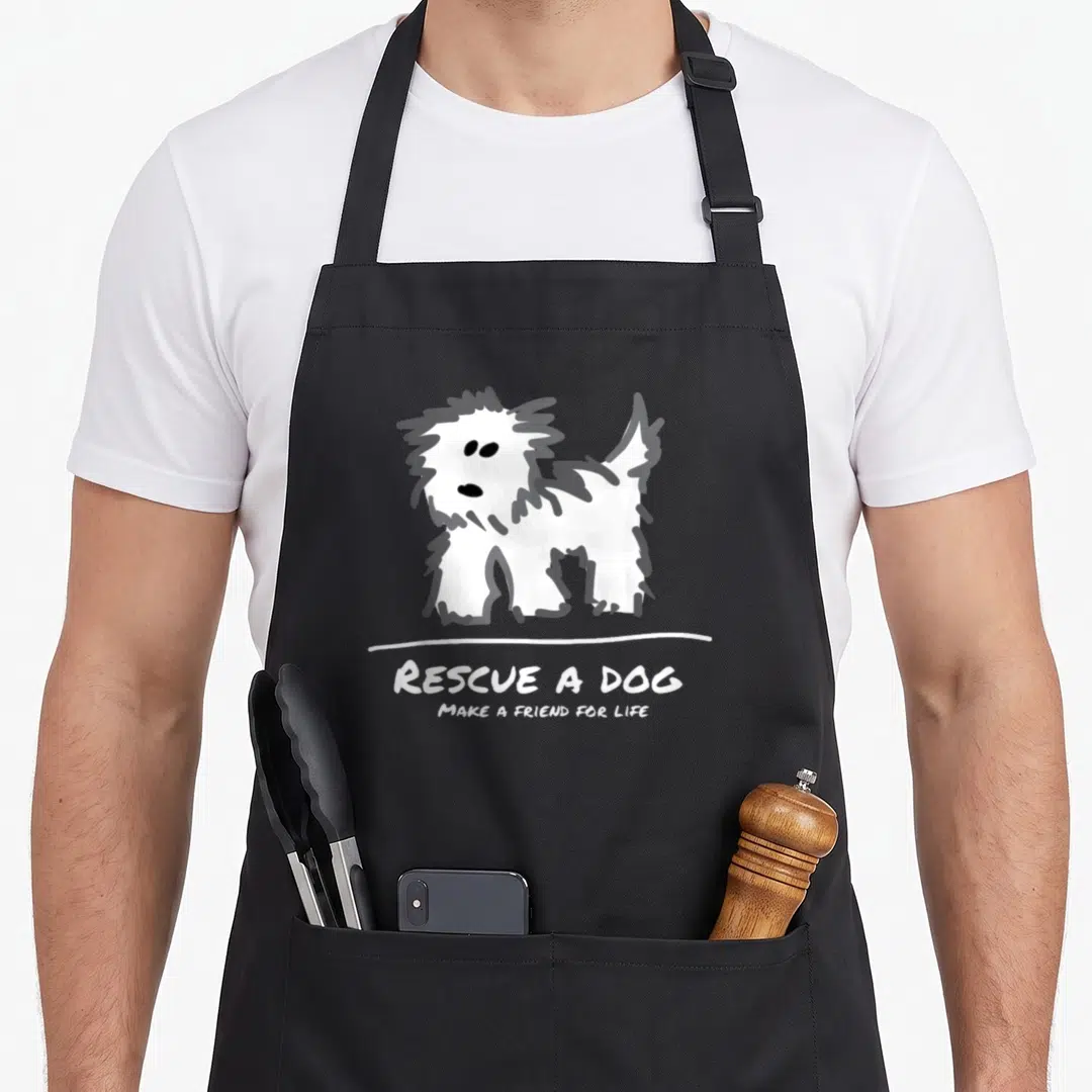 Dog shop grill rescue apron - White cartoon dog above text Rescued a Dog Make a Friend for Life — shown on a black cotton canvas apron against a white background