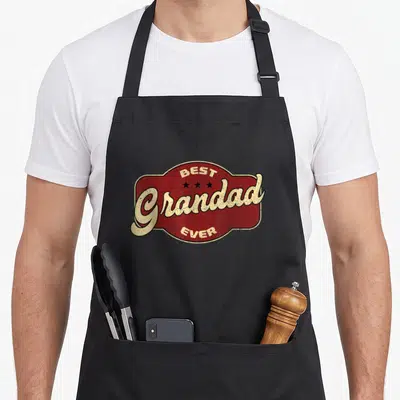 Funny grandad aprons - Red badge with BEST Grandad EVER text and three stars in retro style — shown on a black cotton canvas apron against a white background