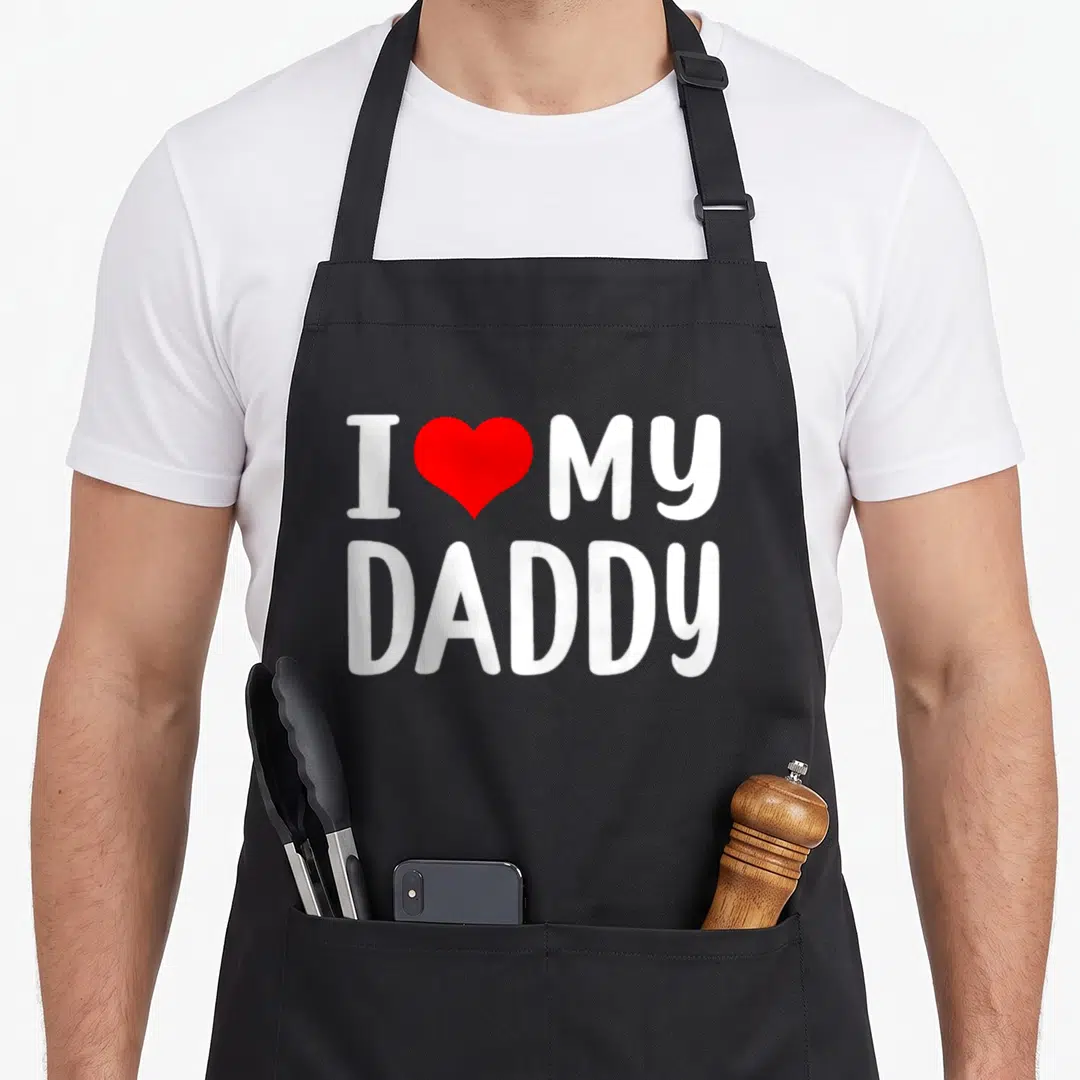 Funny daddy grandad aprons - White text I Love My Daddy with red heart graphic on canvas fabric — shown on a black cotton canvas apron against a white background