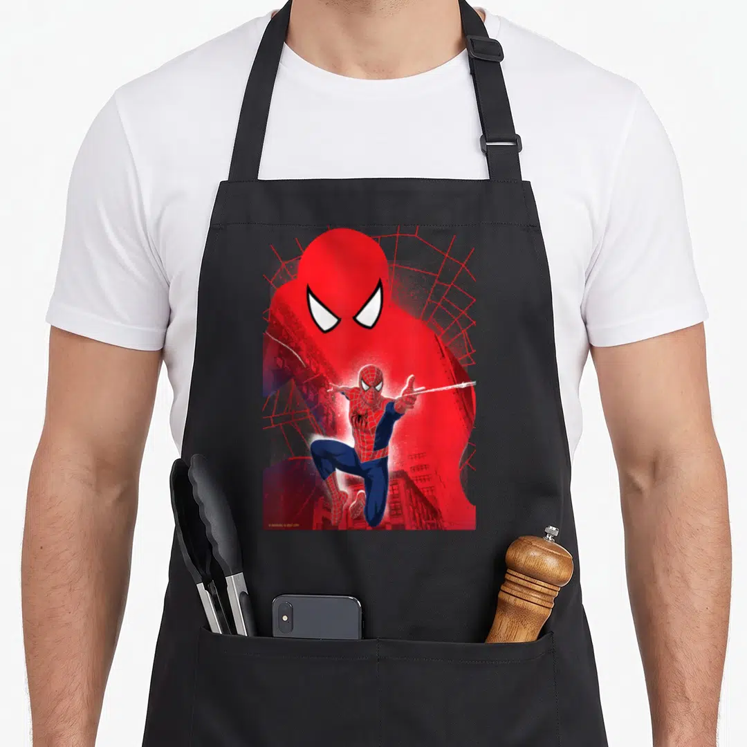 Neighborhood novelty apron - Spider-Man leaping in front of large red head silhouette with white web lines on black — shown on a black cotton canvas apron against a white background
