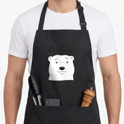 Coca cola bear apron - White polar bear head with black outline and Coca-Cola script logo above in line art style — shown on a black cotton canvas apron against a white background